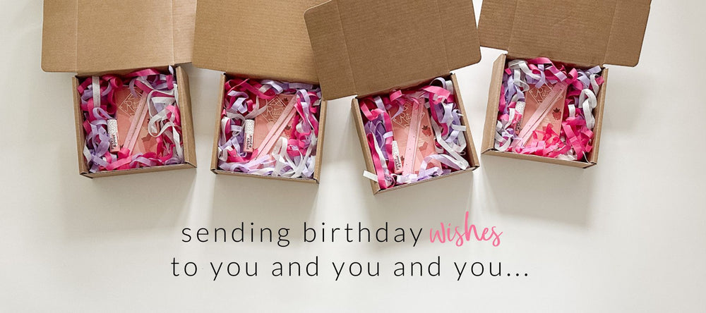 Birthday gift boxes for her displayed with gifts + shredded colorful tissue in the box and a birthday message at the bottom of the image.