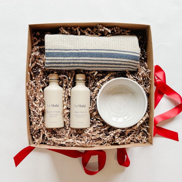 A gift box bundle with oil and vinegar, a handmade dipping bowl, and a hand towel is our bestselling thank you gift.