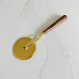 be Home gold and wood pizza wheel. A cute addition to a foodie gift.