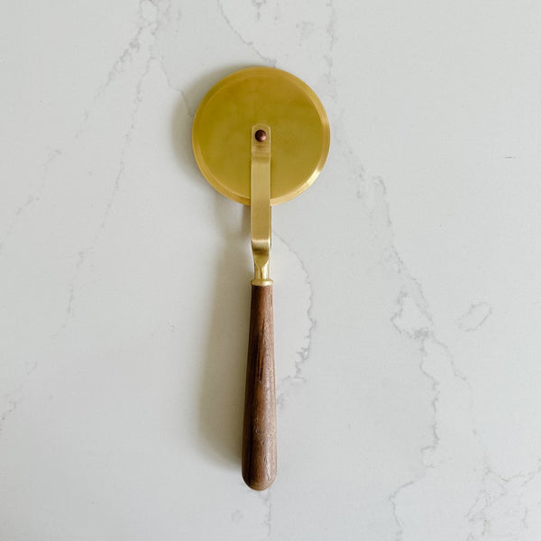 be Home gold and wood pizza cutter.
