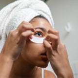 Woman applaying Pure Sol. eye masks.