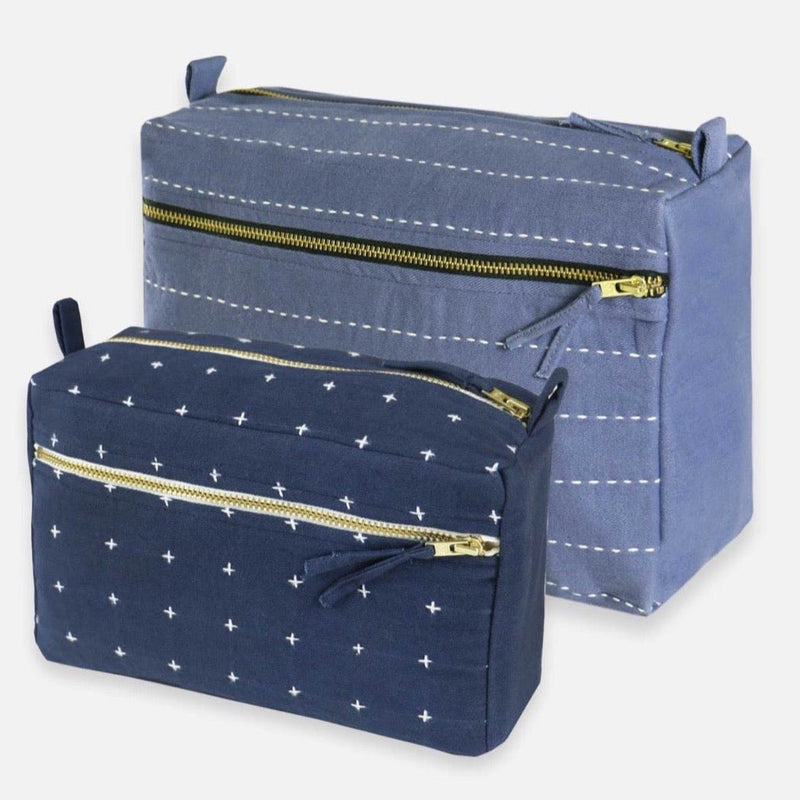 Large slate bag next to smaller navy toiletry bag.