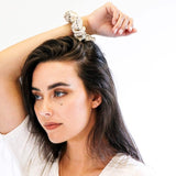 Woman with anchal scrunchie on her wrist.