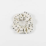 White and navy scrunchie from Anchal.