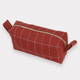 Anchal rust colored make-up bag.