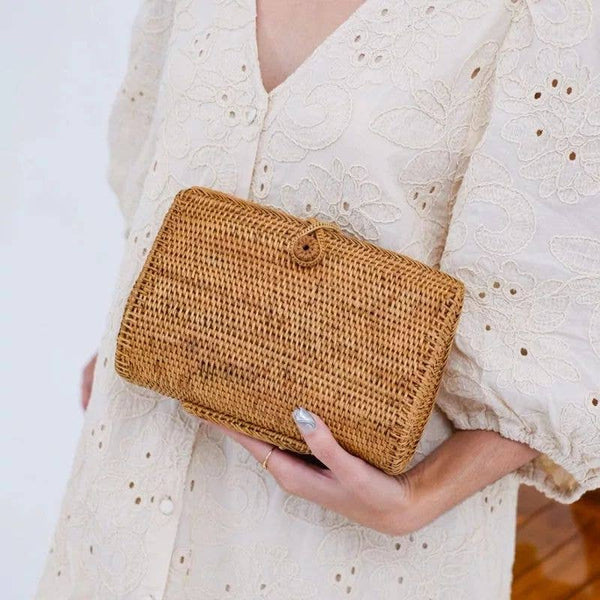 Woman holding a beautiful rattan clutch from Bali Harvest. A perfect birthday gift for a Spring Birthday.