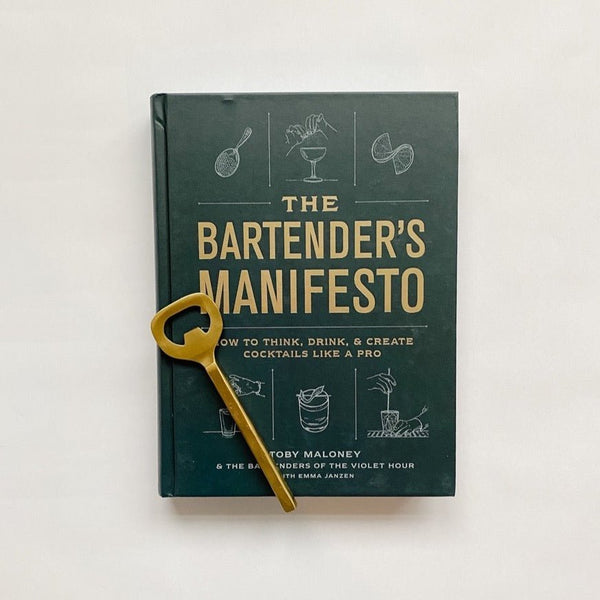 Bartender's Manifesto book paired with a matte gold bottle opener. A gorgeous gift for the home bartender!