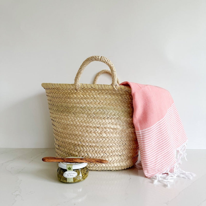 Great summer gift featuring a market basket, Turkish towel, and Bella Cucina pesto and spreader.