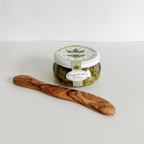 A 6oz. arugula and pine nut pesto from Bella Cucina and an olive wood spreader.