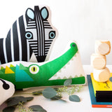 Crocodile pillow next to a zebra pillow and some blocks.  Hand-made by Bibu.