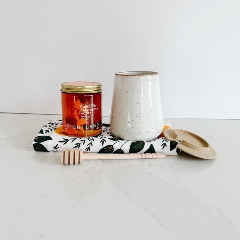 Sweetest gift for a new home includes this m. bueno honey jar and dipper and Brightland orange blossom honey.