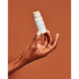 Hand holding tube of lip butter from BIPOC owned Butter Love Skin.