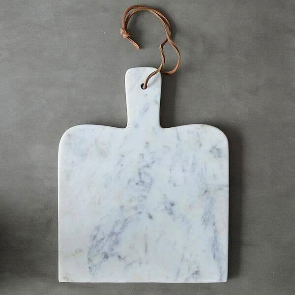 An elevated cheese board like this marble paddle board from caravan home makes the best gift for all occasions.
