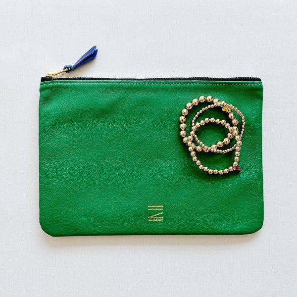 Gorgeous collection of Shashi bracelets paired with Certain Standard green leather pouch.