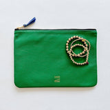 Certain Standard leather pouch in green and beige featured with Shashi bracelets.