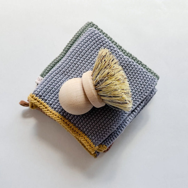 A simple yet beautifully thoughtful gift from East Third Collective includes soft kitchen towels and a wood scrubber.