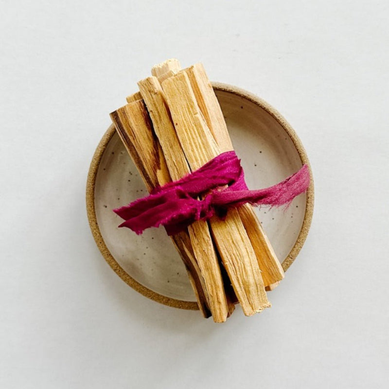Palo santo sticks paired with a beautiful handmade burning dish from m.bueno.