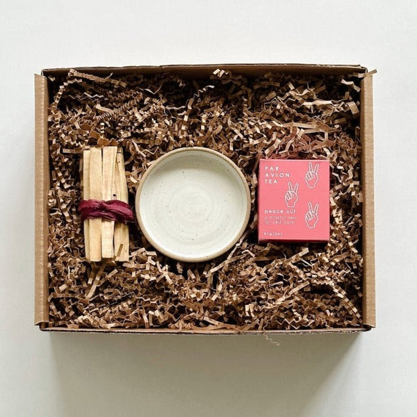 Palo santo sticks paired with a beautiful handmade burning dish from m.bueno and Peace Out tea.
