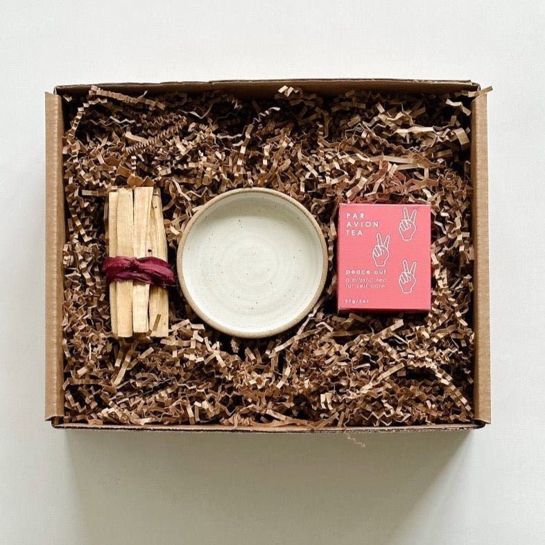 Palo santo sticks paired with a beautiful handmade burning dish from m.bueno and Peace Out tea.