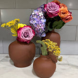 Floral society vases in earth color with bright blooms.