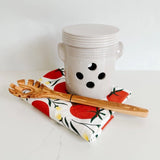 French Dry Goods garlic pot paired with a wooden pasta spoon and Hazelmade tomato tea towel.