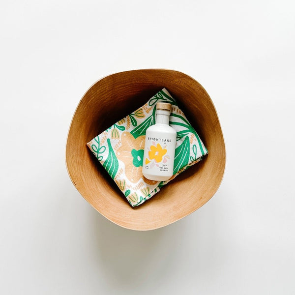 Gingiber tea towel, Brightland Olive Oil and a beautiful BeHome Wood Bowl are a great gift for your hosts this summer.