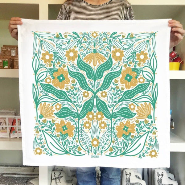 A beautiful aqua and gold floral tea towel from Gingiber in meadow.