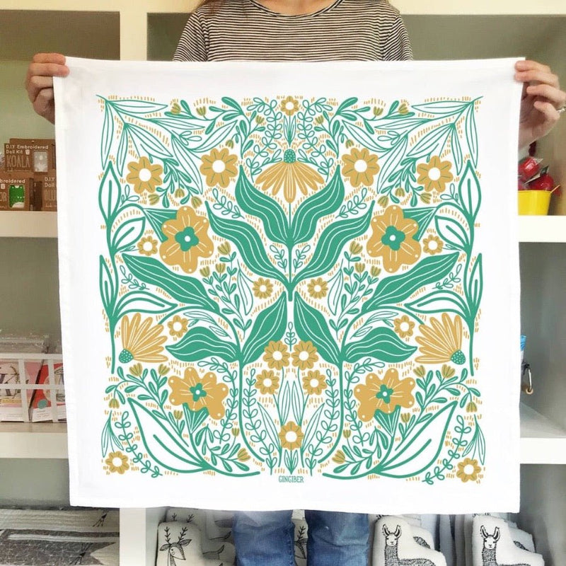 A beautiful aqua and gold floral tea towel from Gingiber in meadow.