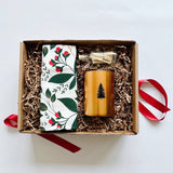 Pretty winterberry tea towel paired with a balsam candle and matches make a perfect holiday gift.