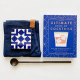Hedley and Bennett apron paired with Cocktail book, long spoon, and pretty tile coasters.