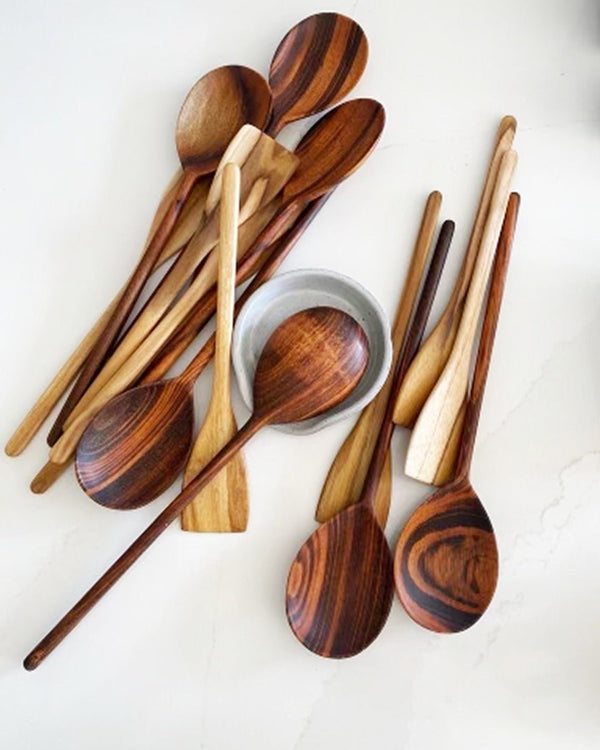 Spoon rest with several several wooden spoons.