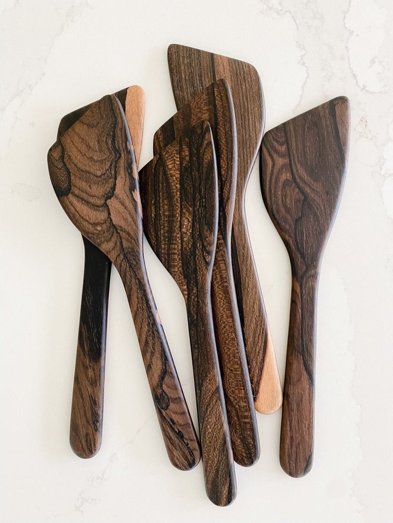 Several beautiful wood spatulas.
