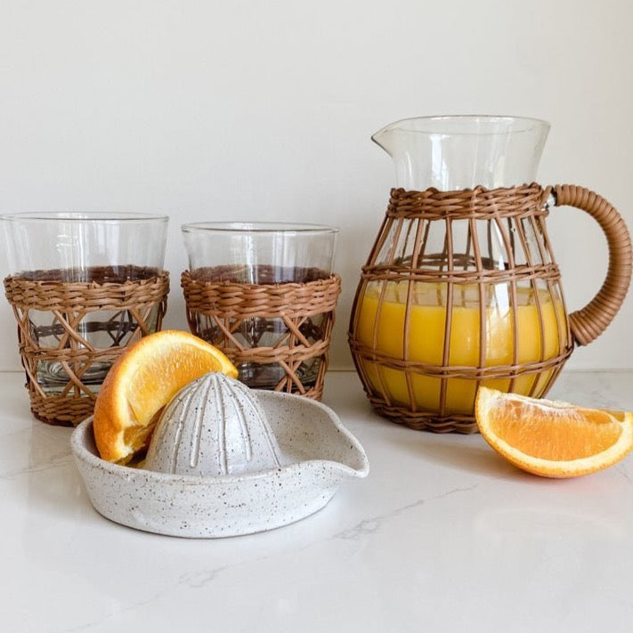 Enjoy a perfect morning with rattan pitcher and tumblers paired with a handmade juicer. A great host gift.