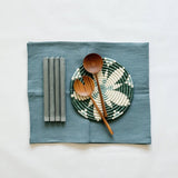 Magic Linen table runner featuring a Kazi trivet, beautiful salad servers and grey/blue candlesticks.