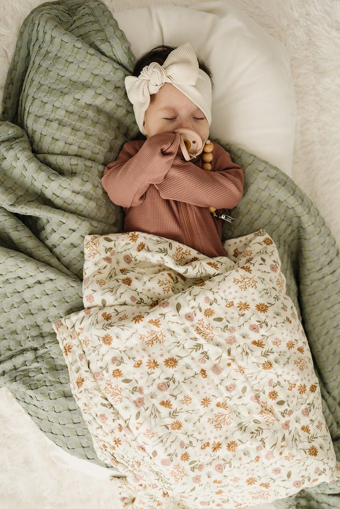Mebie Baby muslin swaddle blanket in meadow floral .