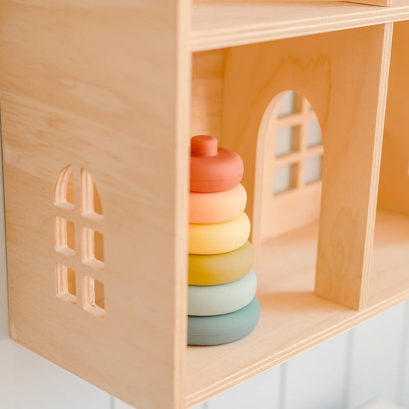 OB Design Silicone cherry stacker inside a wood toy house.