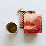 Ritual drinking chocolate paired with a beautiful handwoven potholder and mug. Just like sending a warm hug.