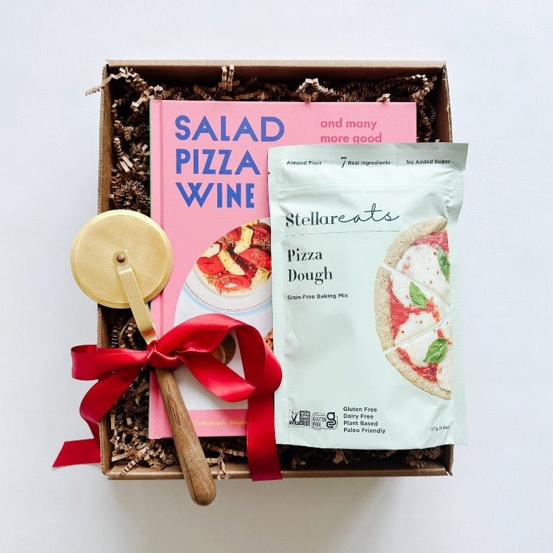 A perfect host gift box that includes an East Third Collective pizza set and a Salad Pizza Wine cookbook for the pizza and wine lover.