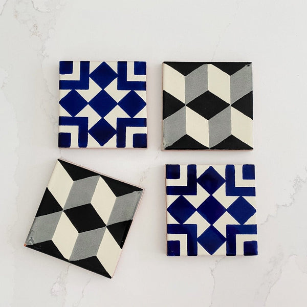 Talavera tile coasters in black and white and blue and white combinations.