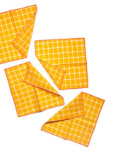 Four Teach Windowpane Cocktail napkins from Willow Ship in a yellow orange color.