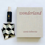 Annie Leibovitz Wonderland book paired perfectly with tile coasters and sweet balsam room spray.
