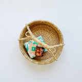 Woven basket paired with a kitchen towel and california honey. A sweet way to say thanks.