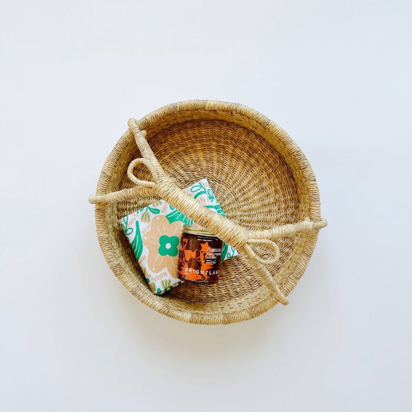 Woven basket paired with a kitchen towel and california honey. A sweet way to say thanks.