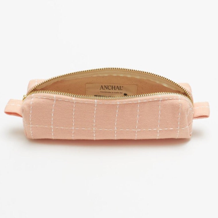 Small grid stitch toiletry bag in pale pink color with zipper.