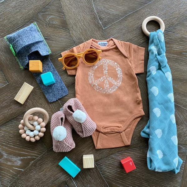 Polished prints peace onesie and sunglasses and alimrose pink baby bootie. Cute gift!