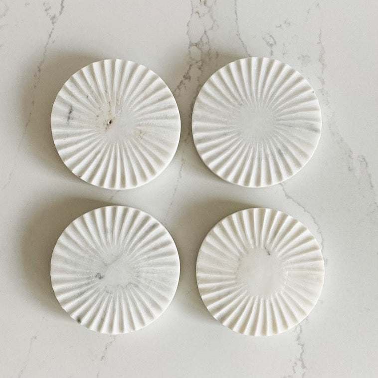 These fantastic spiral white marble coasters form beHome are an eye-catching accent to any tablescape. 