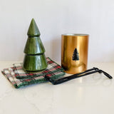 A stunning holiday collection including green stoneware tree, tartan table linens, gold candle and wick trimmers.