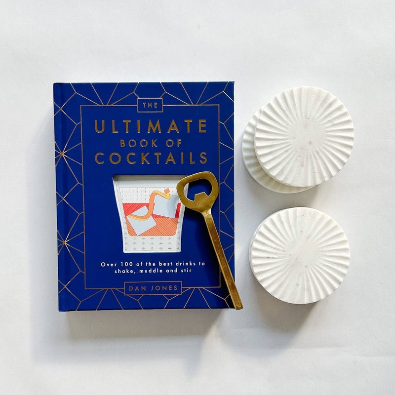 Pretty marble coasters paired with The Ultimate Book of Cocktails and a gold bottle opener.