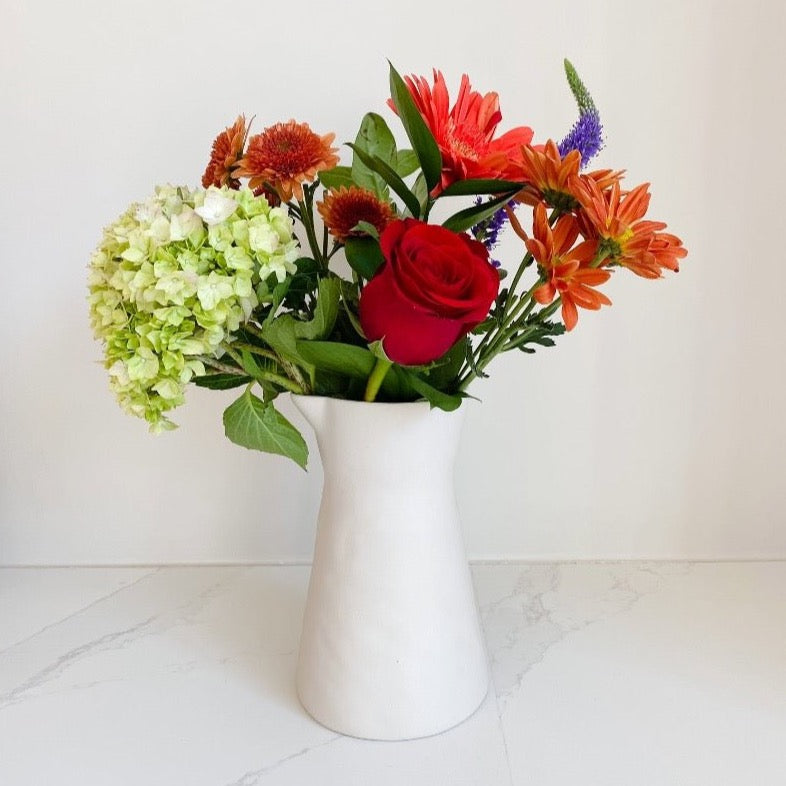 Beautiful floral arrangement in a stoneware carafe from BeHome.