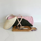 A picnic perfect pink and gray blanket from caminito, a straw sun visor from Bali Harvest, a Le Régal French Oak Board and mini cheese set in ivory from Laguiole.